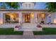 Charming home featuring a welcoming front porch with seating, decorative flower boxes, and a stylish arched front door at 1379 S Claiborne Ave, Gilbert, AZ 85296