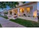 Inviting front porch with brick trim, colorful flower beds, and charming seating area, perfect for relaxing at 1379 S Claiborne Ave, Gilbert, AZ 85296