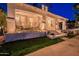 Beautifully lit front porch with seating, landscaping and flowers at dusk. The address number is visible above the front door at 1379 S Claiborne Ave, Gilbert, AZ 85296
