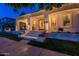 Inviting front porch with cozy seating, elegant brick trim, and lush flower boxes, creating a welcoming entrance at 1379 S Claiborne Ave, Gilbert, AZ 85296