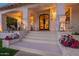 Charming front porch with seating areas, brick accents, decorative plants and stylish front door entrance at 1379 S Claiborne Ave, Gilbert, AZ 85296