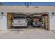 Spacious garage with ample storage and parking space for multiple vehicles and a golf cart at 1379 S Claiborne Ave, Gilbert, AZ 85296