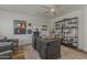 Well-appointed home office featuring a large desk, built-in shelving, and comfortable seating at 1379 S Claiborne Ave, Gilbert, AZ 85296