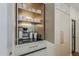 Custom kitchen cabinetry featuring a coffee bar with a built-in espresso machine and storage shelves at 1379 S Claiborne Ave, Gilbert, AZ 85296