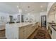 Spacious kitchen features a large marble island, white farmhouse sink and stainless steel appliances at 1379 S Claiborne Ave, Gilbert, AZ 85296