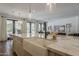 Kitchen island with seating, a white farmhouse sink, and stainless steel appliances at 1379 S Claiborne Ave, Gilbert, AZ 85296