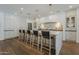 Kitchen with white cabinetry, marble countertops, a long island and pendant lighting at 1379 S Claiborne Ave, Gilbert, AZ 85296