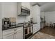 Modern kitchen features stainless steel appliances, sleek black countertops, and white cabinets at 1379 S Claiborne Ave, Gilbert, AZ 85296