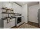 Bright laundry room boasts modern appliances, white cabinets and an undermount sink with stylish fixtures at 1379 S Claiborne Ave, Gilbert, AZ 85296