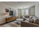 Comfortable living room featuring a large sofa and modern entertainment center at 1379 S Claiborne Ave, Gilbert, AZ 85296