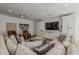 Spacious living room boasts a large TV, plush seating, and built-in storage at 1379 S Claiborne Ave, Gilbert, AZ 85296