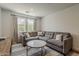Relaxing living area with large sectional couch, stylish decor and two large windows at 1379 S Claiborne Ave, Gilbert, AZ 85296