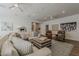 Bright living room with large sofa, hardwood floors, ceiling fans, and stylish decor at 1379 S Claiborne Ave, Gilbert, AZ 85296