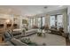 Open-concept living room featuring a neutral color palette, wood floors, and abundant natural light at 1379 S Claiborne Ave, Gilbert, AZ 85296