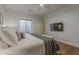 Comfortable main bedroom with a cozy bed, stylish armoire, mounted TV, and natural light at 1379 S Claiborne Ave, Gilbert, AZ 85296