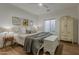 Comfortable main bedroom with a cozy bed, stylish armoire, ceiling fan, and natural light at 1379 S Claiborne Ave, Gilbert, AZ 85296