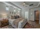 This comfortable main bedroom features wood floors, a ceiling fan, and windows for natural light at 1379 S Claiborne Ave, Gilbert, AZ 85296
