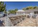 Outdoor kitchen featuring a stone bar with seating and a built-in grill, perfect for entertaining guests at 1379 S Claiborne Ave, Gilbert, AZ 85296
