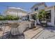 Outdoor kitchen area featuring a built-in grill, bar seating, and a shaded patio for outdoor dining at 1379 S Claiborne Ave, Gilbert, AZ 85296