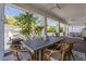 Inviting covered patio with a dining table, chairs, outdoor kitchen, and a view of the sparkling pool at 1379 S Claiborne Ave, Gilbert, AZ 85296