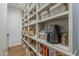 Walk-in pantry with custom shelving and storage, offering plenty of room for organization at 1379 S Claiborne Ave, Gilbert, AZ 85296