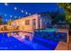 Outdoor view of a beautiful pool and spa at dusk with string lights overhead, next to the home and an outdoor bar at 1379 S Claiborne Ave, Gilbert, AZ 85296