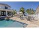 Inviting backyard pool area with a built-in bar, cozy fire pit, and comfortable lounge seating at 1379 S Claiborne Ave, Gilbert, AZ 85296