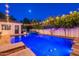 Outdoor view of a sparkling pool and spa at dusk, string lights overhead and a privacy fence at 1379 S Claiborne Ave, Gilbert, AZ 85296