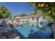 Beautiful pool with an integrated jacuzzi surrounded by lounge chairs and an outdoor kitchen at 1379 S Claiborne Ave, Gilbert, AZ 85296