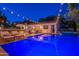 Outdoor view of a beautiful pool and spa at dusk with string lights overhead, next to the home and an outdoor bar at 1379 S Claiborne Ave, Gilbert, AZ 85296