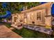 Beautifully lit front porch with seating, landscaping and flowers at dusk at 1379 S Claiborne Ave, Gilbert, AZ 85296