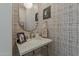 Quaint powder room features patterned wallpaper, a marble countertop, and decorative gold accents at 1379 S Claiborne Ave, Gilbert, AZ 85296
