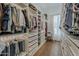 A spacious walk-in closet with custom shelving, drawers, and hanging racks providing ample storage space at 1379 S Claiborne Ave, Gilbert, AZ 85296