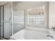 Bathroom features a tub and shower combo with glass block window at 14625 W Redfield Rd, Surprise, AZ 85379