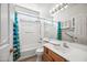 Bathroom featuring a single vanity and shower-tub combo with curtains at 14625 W Redfield Rd, Surprise, AZ 85379
