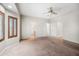 A large bedroom with a carpet floor and a bay window with wooden shutters at 14625 W Redfield Rd, Surprise, AZ 85379