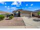 Charming one-story home with a two-car garage, desert landscaping and concrete driveway at 14625 W Redfield Rd, Surprise, AZ 85379