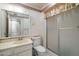 Cozy bathroom featuring a vanity, toilet, and a glass-enclosed shower stall at 15438 N Lakeforest Dr, Sun City, AZ 85351