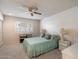 Serene bedroom with a ceiling fan, soft colors, and a comfortable-looking bed at 15438 N Lakeforest Dr, Sun City, AZ 85351