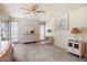 Spacious bedroom with ceiling fan and a coordinated vanity set with lamps at 15438 N Lakeforest Dr, Sun City, AZ 85351
