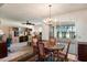 Open dining area with a chandelier, seamlessly connected to the adjacent living spaces at 15438 N Lakeforest Dr, Sun City, AZ 85351