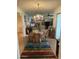 View of a dining room featuring a decorative chandelier, wood flooring, and decorative rug at 15438 N Lakeforest Dr, Sun City, AZ 85351
