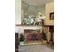 Fireplace with tile surround, decorative mantel, and mirrored accents at 15438 N Lakeforest Dr, Sun City, AZ 85351