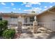 Close-up of the home's front porch with decorative railing and vintage-style lamps at 15438 N Lakeforest Dr, Sun City, AZ 85351