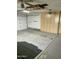 Spacious garage featuring a ceiling fan and built-in storage cabinets at 15438 N Lakeforest Dr, Sun City, AZ 85351