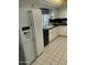 Bright kitchen featuring white cabinets, black countertops, and a stainless steel refrigerator at 15438 N Lakeforest Dr, Sun City, AZ 85351