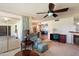 Relaxing living area featuring a recliner, ceiling fan, and a glimpse into adjacent rooms at 15438 N Lakeforest Dr, Sun City, AZ 85351