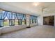 Bright sunroom features tile flooring, many windows, and a ceiling fan at 15438 N Lakeforest Dr, Sun City, AZ 85351