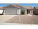 Single-level home with a front-facing two-car garage and low-maintenance desert landscaping at 2350 E Nunneley Ct, Gilbert, AZ 85296