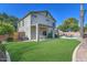 Charming backyard with a covered patio, inviting pool, and green grass, perfect for relaxation at 2545 E Harrison Ct, Gilbert, AZ 85295